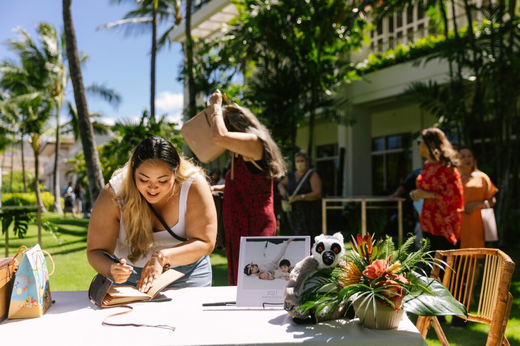 signing the guestbook at the start of birthday luau at the four seasons oahu