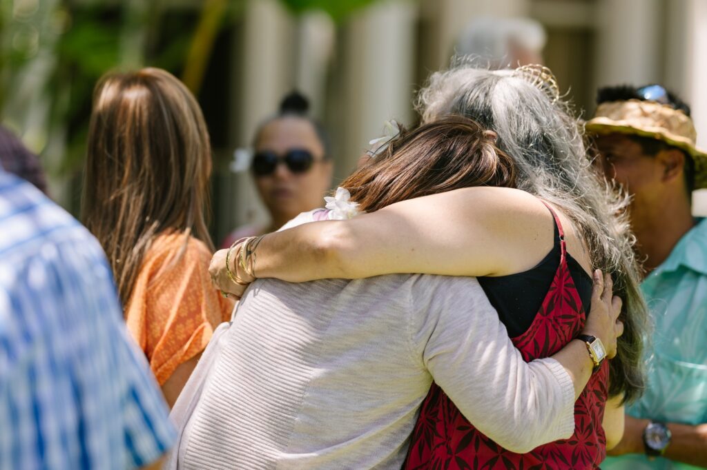 guests hug during a birthday party