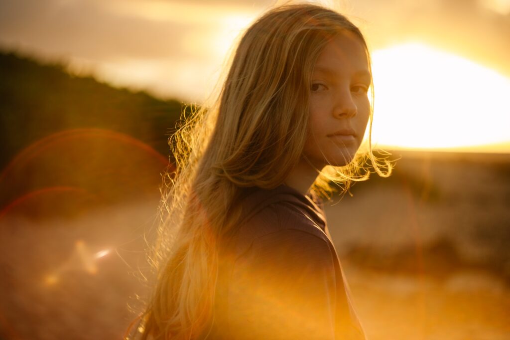 portrait of a girl at sunrise at sandy beach park on oahu