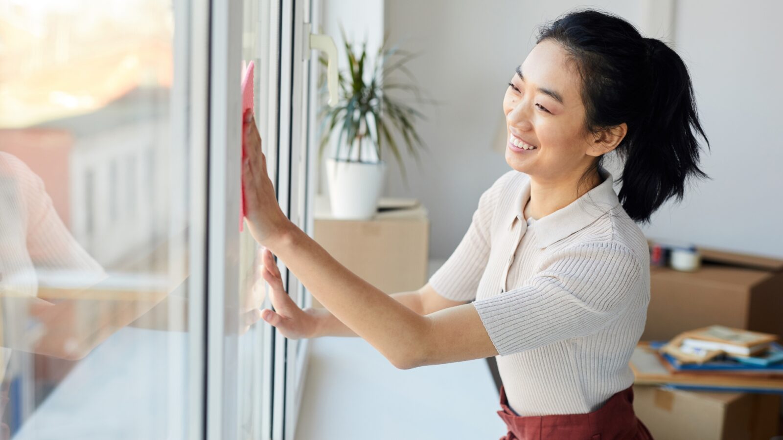 woman cleaning a house to prep it for a home exchange