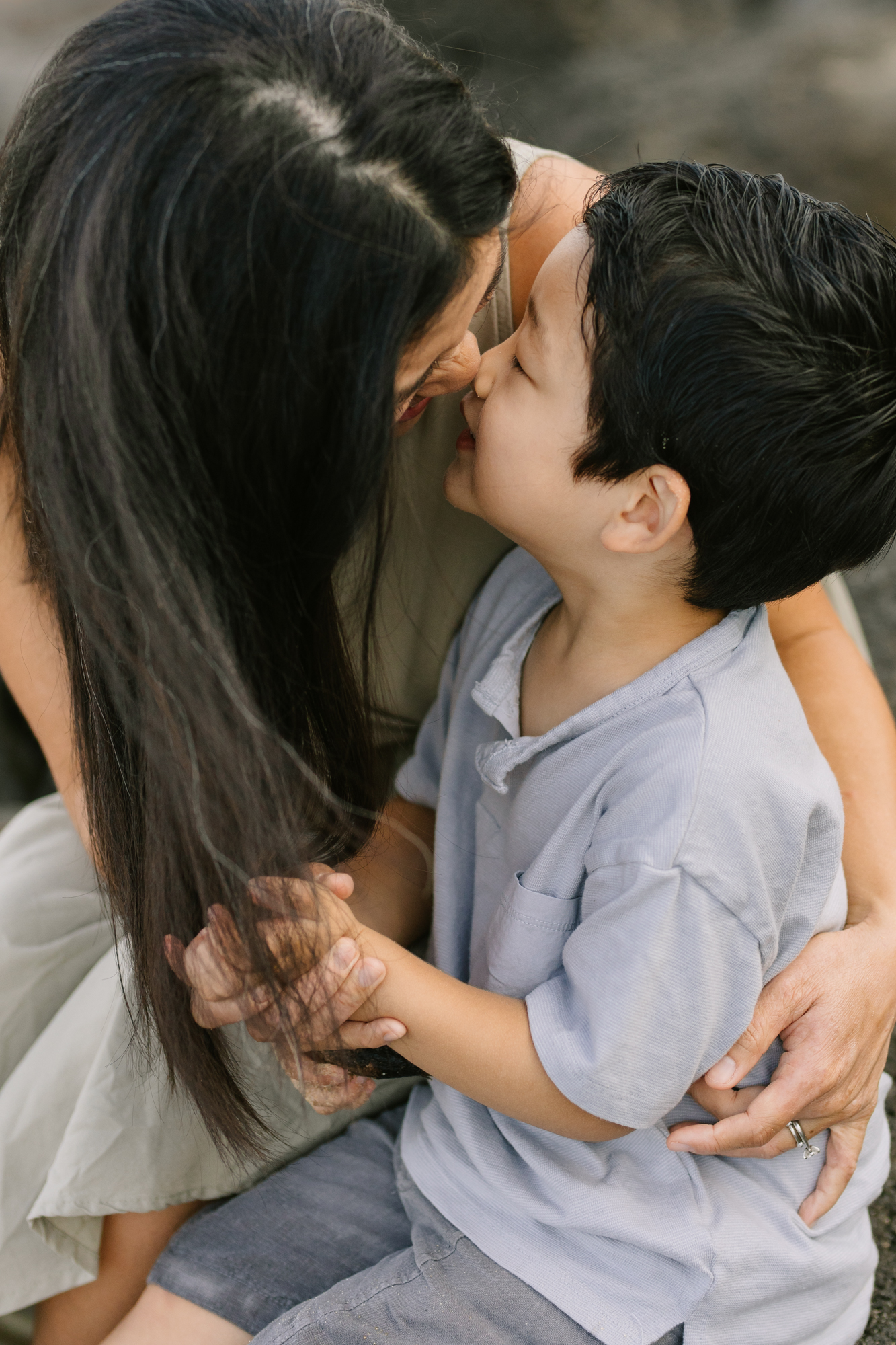 mom nose to nose with son during family photo shoot in hawaii