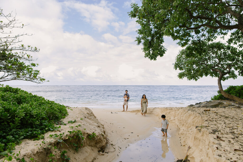 family exploring a quiet beach in oahu hawaii