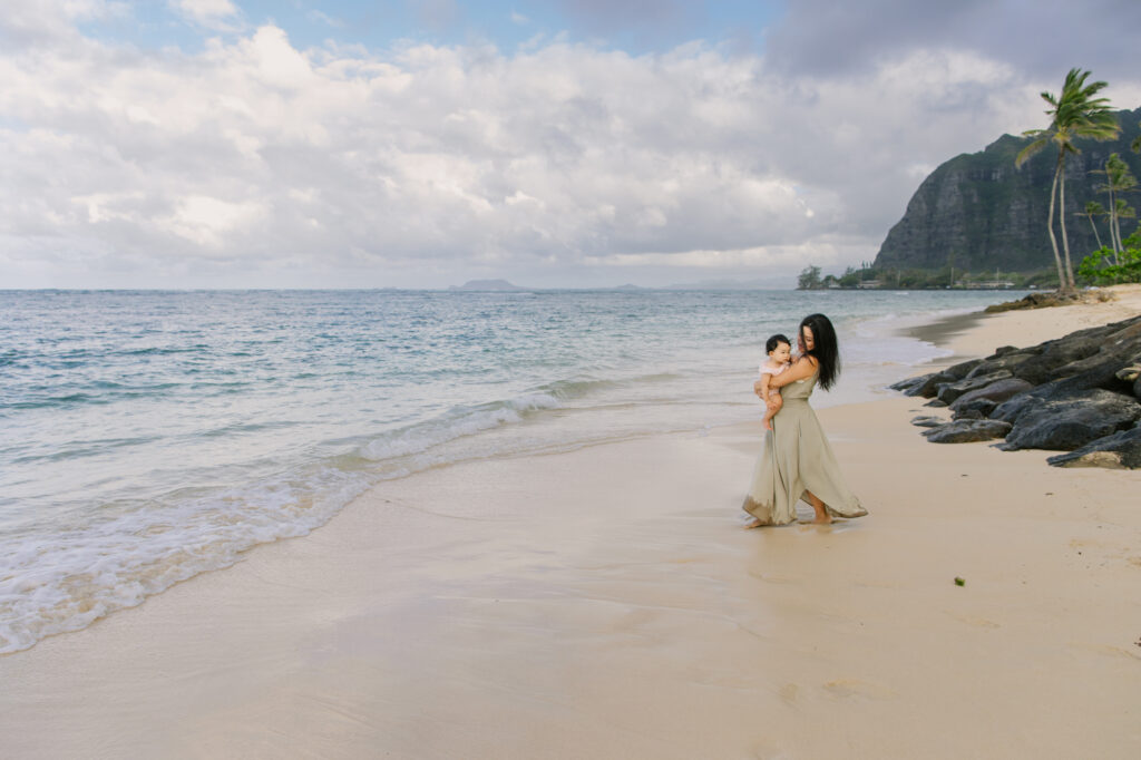 mom and baby daughter at kaaawa beach for family photography session in hawaii