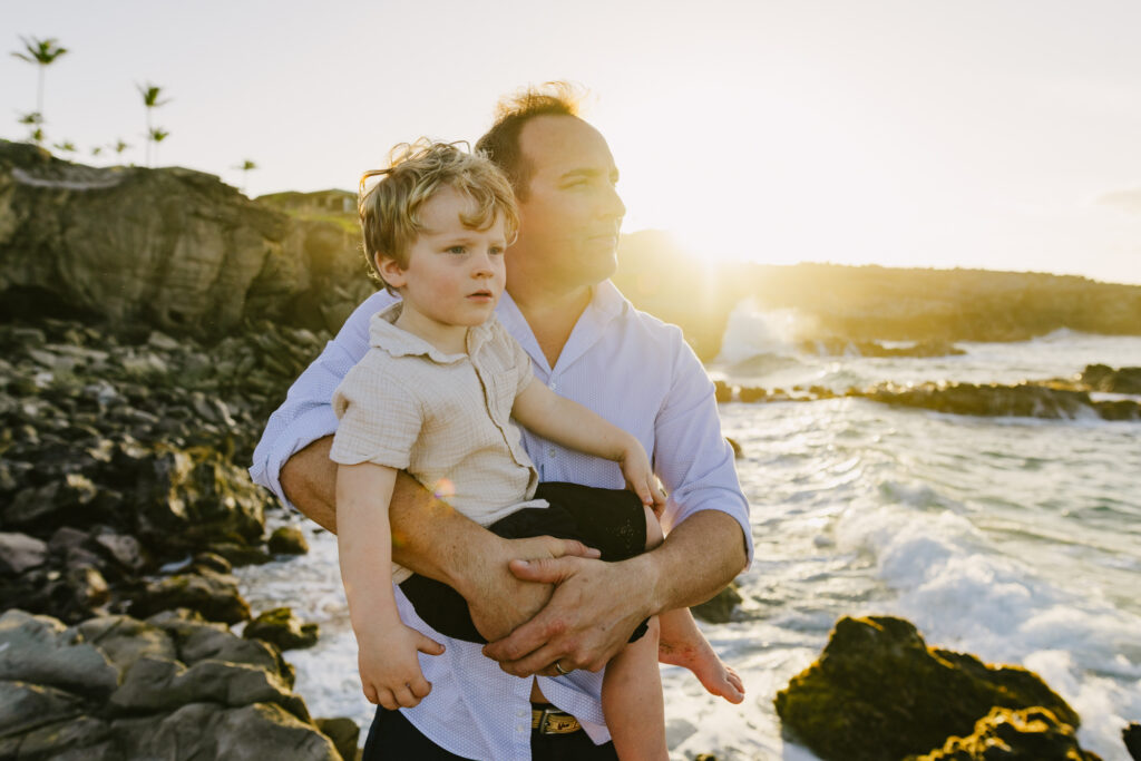 dad holding son during maui family photos at sunset