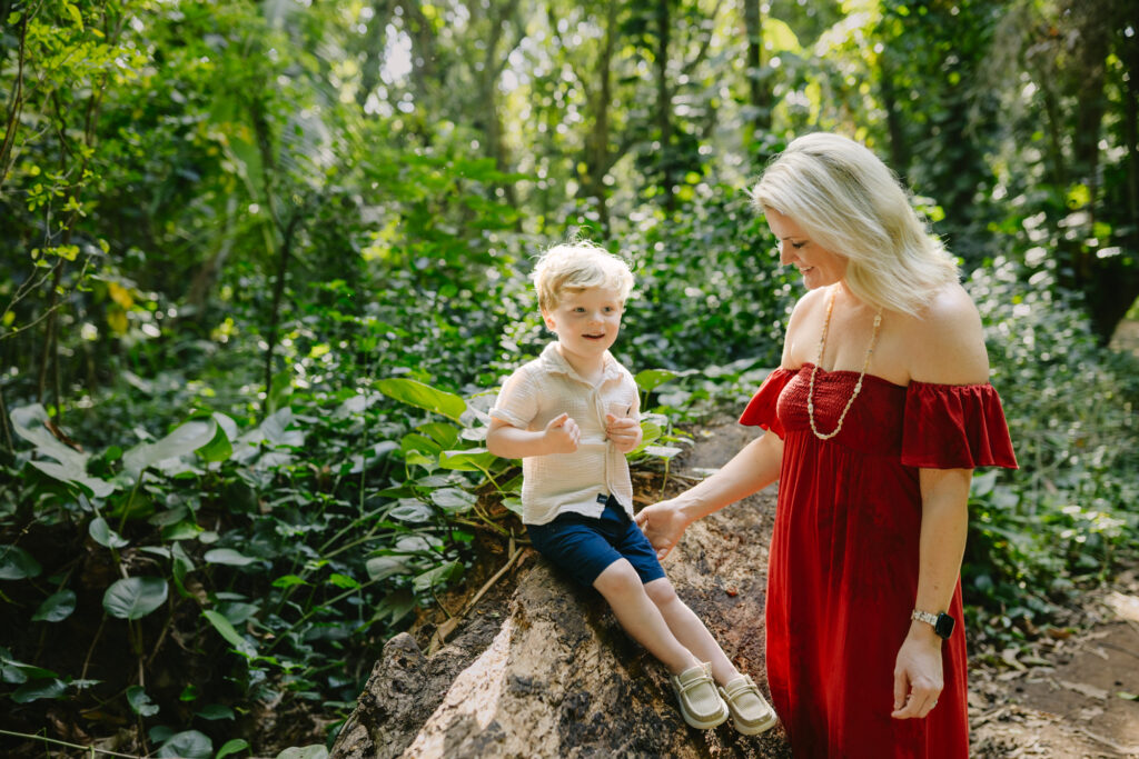 mom and son on a log during maui family photos