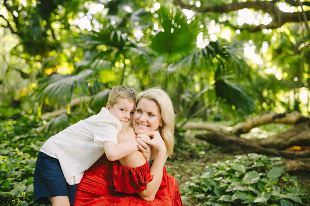 mom and son hug during maui family photos in the rainforest