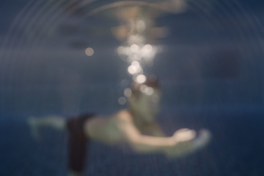 boy swimming under water