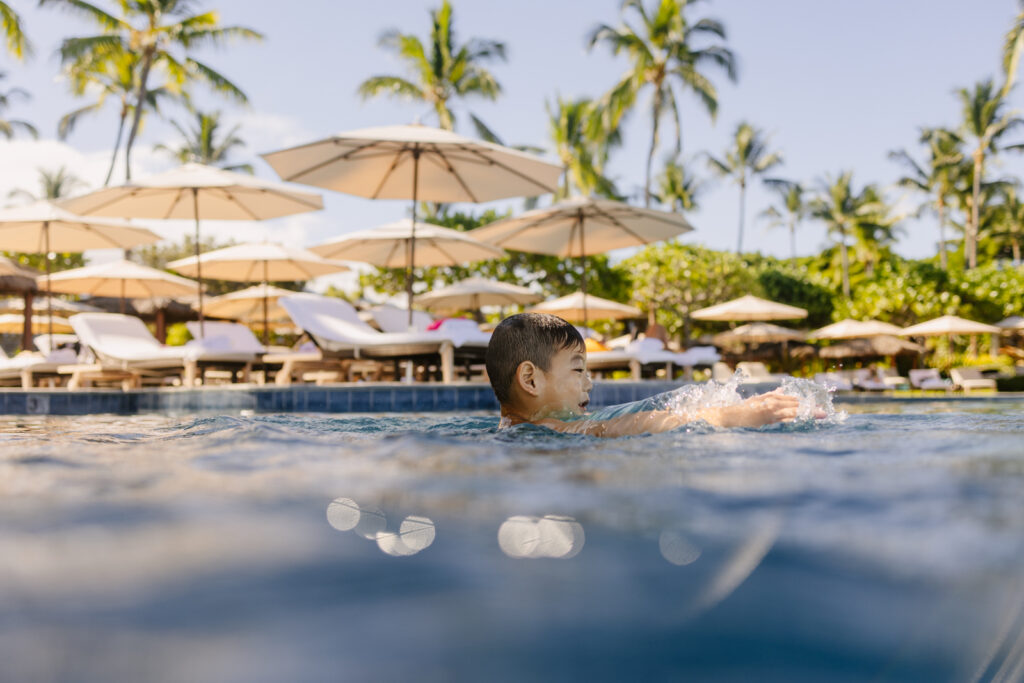 boy swimming in the pool at kona resort