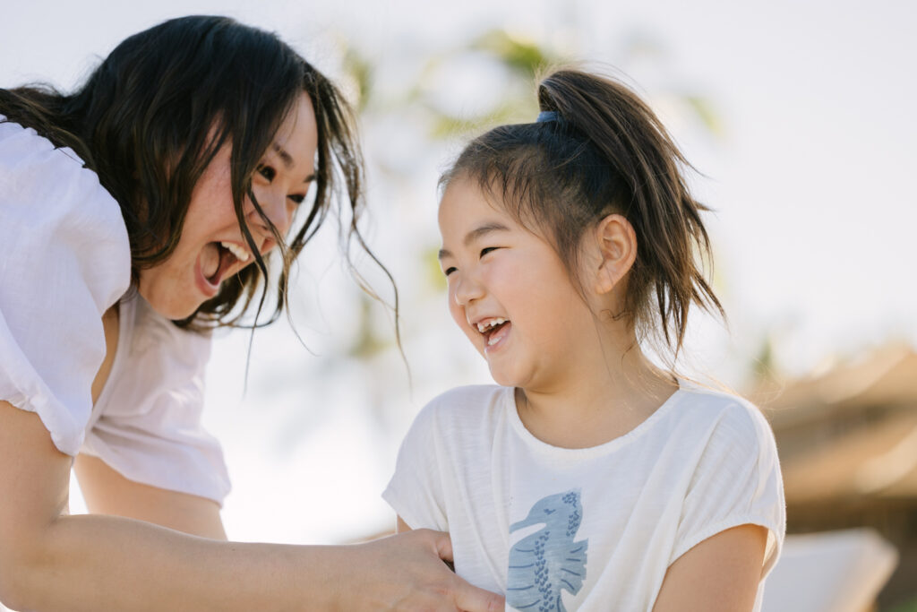 mom and daughter play during a hawaii family photo session