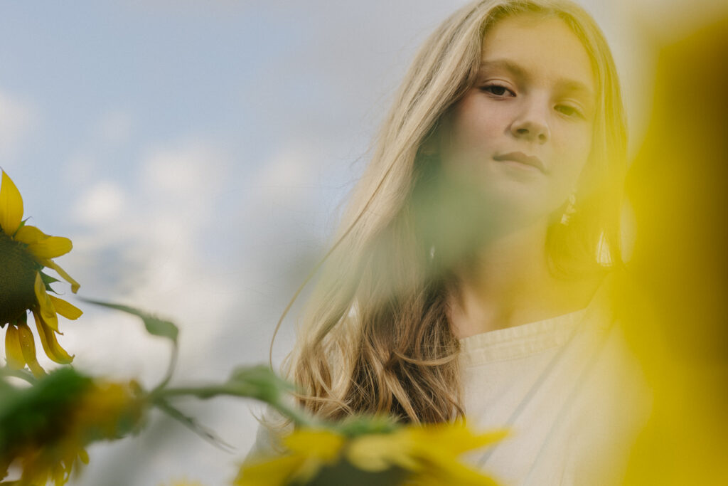 portrait partially hidden by sunflowers in oahu